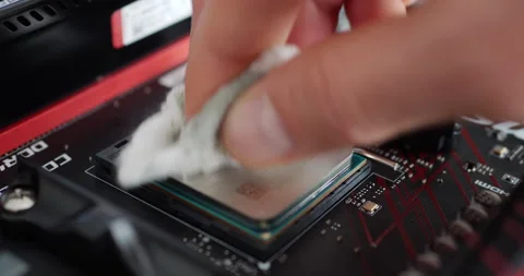 A computer repair technician installing an AMD Ryzen 2400G cpu on a Stock Footage 139075475