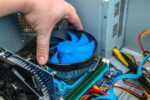 A computer repair wizard changes the processor cooling system on the motherboard 写真素材