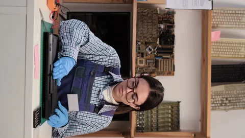 Computer repairman assembling laptop after repair and upgrade working in service Stock Footage 233663943