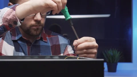 Computer repairman disassembles the PC system unit Stock Footage 115084718