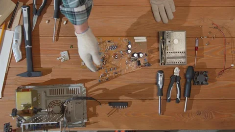 Computer repairman examines the circuit. Top view Stock Footage 129982300