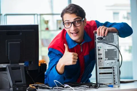 Computer repairman working on repairing computer in IT workshop 스톡 사진