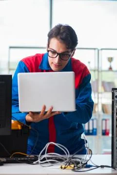 Computer repairman working on repairing computer in IT workshop 스톡 사진