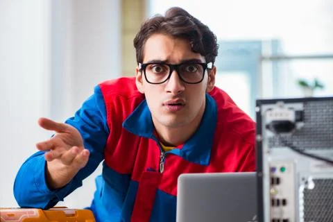Computer repairman working on repairing computer in IT workshop 스톡 사진