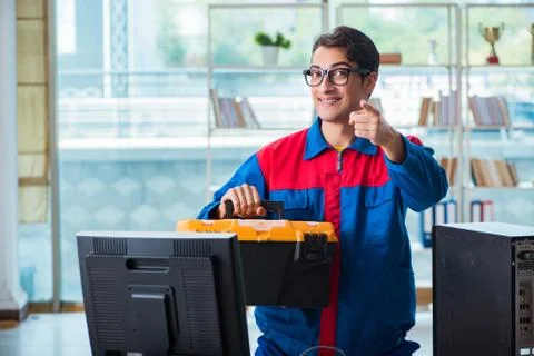 Computer repairman working on repairing computer in IT workshop 스톡 사진