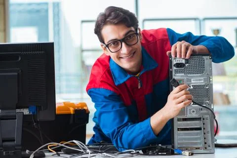 Computer repairman working on repairing computer in IT workshop 스톡 사진