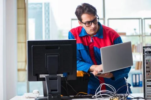 Computer repairman working on repairing computer in IT workshop 스톡 사진