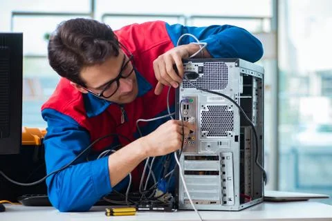 Computer repairman working on repairing computer in IT workshop 写真素材