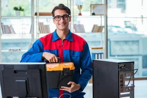 Computer repairman working on repairing computer in IT workshop 库存照片