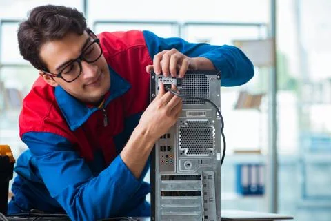 Computer repairman working on repairing computer in IT workshop 스톡 사진