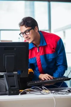 Computer repairman working on repairing computer in IT workshop 스톡 사진