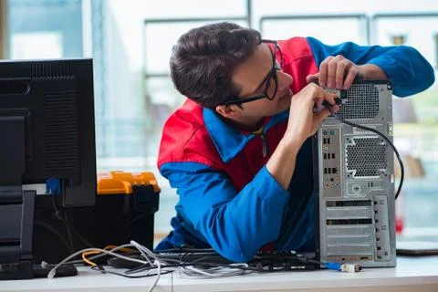 Computer repairman working on repairing computer in IT workshop 스톡 사진