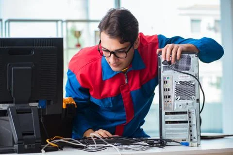 Computer repairman working on repairing computer in IT workshop 스톡 사진