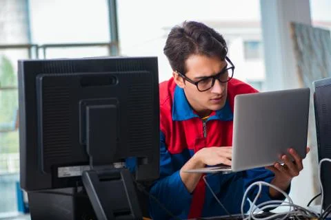 Computer repairman working on repairing computer in IT workshop 스톡 사진