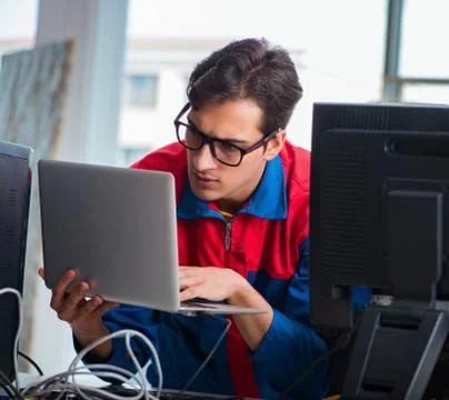 Computer repairman working on repairing computer in IT workshop 스톡 사진