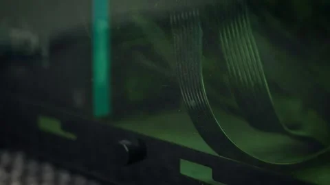 Computer ribbon cables inside dusty case with green ambient lighting. Macro view Stock Footage 337642207