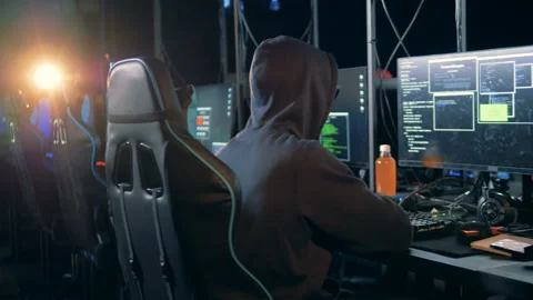 Computer room with a hacker breaking into servers Stock Footage 101576268