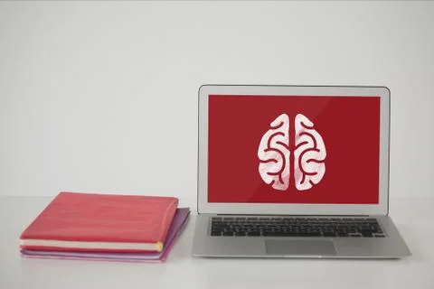 Computer on a school table with brain icon on screen Foto stock