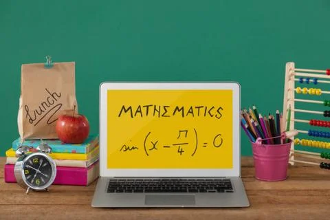 Computer on a school table with school icons on screen 스톡 사진