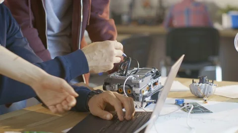 In Computer Science Class Teacher Examines programed Robot Engineered by Kids Stock Footage 75784517