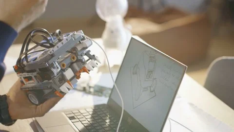 Computer Science Class Teacher Examines programed Robot Sketched and Engineered Stock Footage 75784741