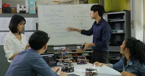 In Computer Science Class Teacher talking to students about robot technology. Stock Footage 94550952