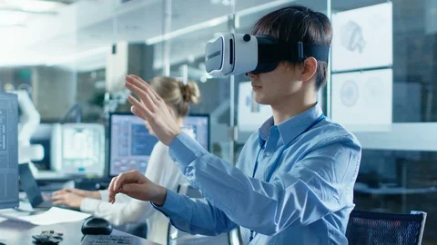 Computer Science Engineer wearing Virtual Reality Headset Works with 3D Stock Footage 85772092