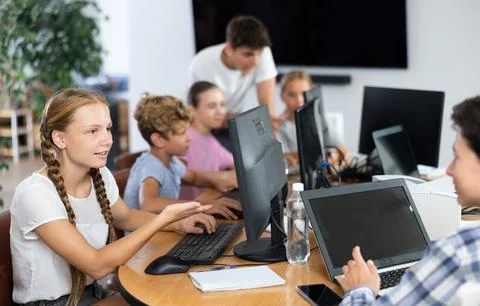Computer science lesson in a school computer class - a girl and a boy solve Stock Photos