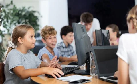 Computer science lesson in a school computer class - a girl and a boy solve Stock Photos