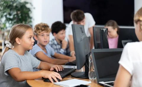 Computer science lesson in a school computer class - a girl and a boy solve Stock Photos