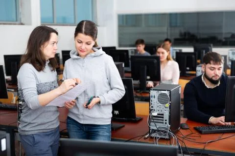 Computer science teacher checks student results Stock Photos