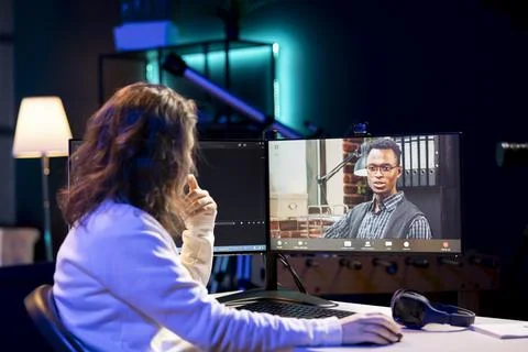 Computer science teacher doing tutoring with student in online videocall 写真素材