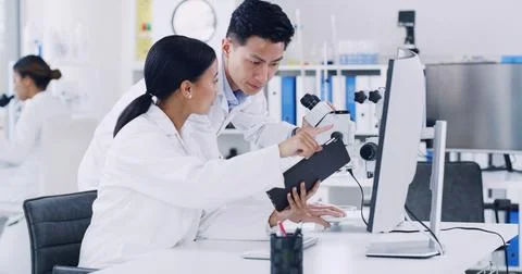 Computer, scientist and discussion with tablet in lab, research biotech inn.. 写真素材
