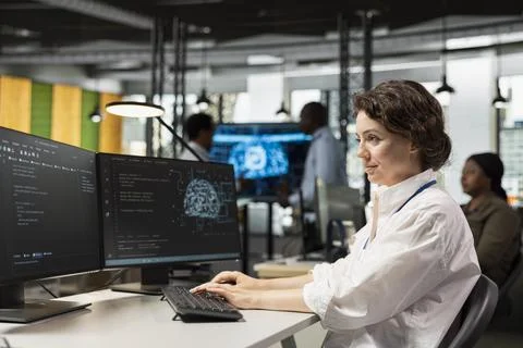 Computer scientist in artificial intelligence tech company workplace coding Stock Photos