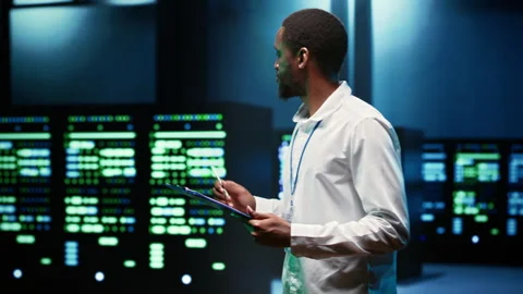 Computer scientist checking server racks Stock Footage 247092294