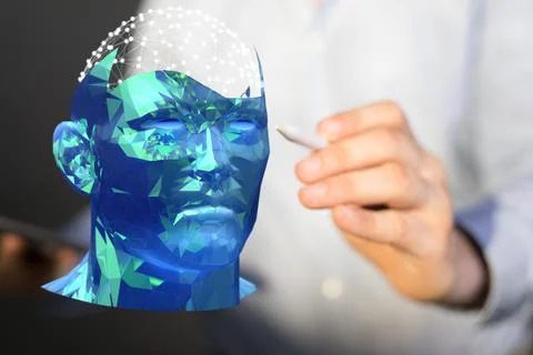 A computer scientist creating a 3D rendering of a cyborg head hologram with a Stock Photos