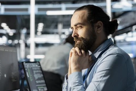 Computer scientist in data center doing software updates, verifying metrics Stock Photos