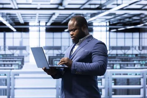 Computer scientist in data center making sure rackmounts are functioning Stock Photos