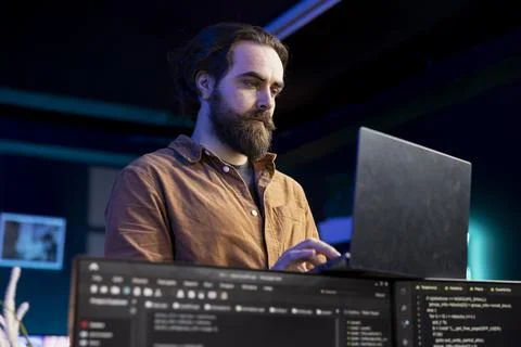 Computer scientist doing software debugging using laptop, checking glitches Stock Photos