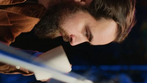 Computer scientist drinking cup of coffee while developing code on PC Stock Footage 265107776