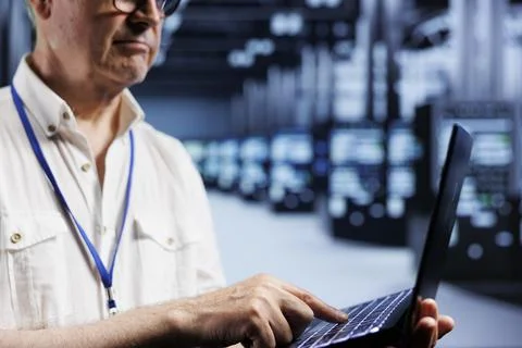 Computer scientist examining servers Stock Photos