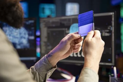 Computer scientist holding disk containing artificial intelligence entity Stock Photos