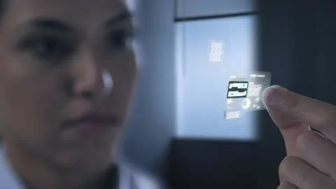 Computer scientist holding a microchip processor holographic interface Stock Footage 186113087