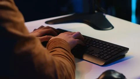 Computer scientist listening music while writing lines of code, extreme close up 写真素材