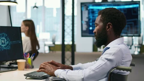 Computer scientist with paraplegia in office automating repetitive tasks with AI Stock Footage 313165740