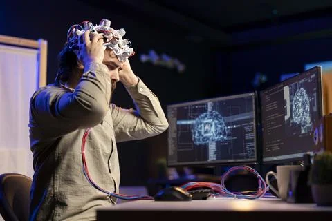 Computer scientist puts EEG headset on, starting mind upload process Stock Photos