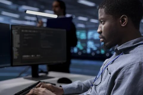 Computer scientist reconfiguring server room equipment, close up Stock Photos