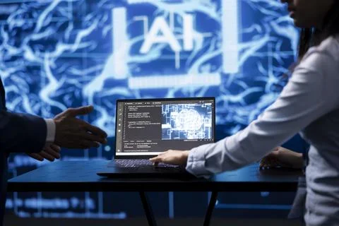 Computer scientist running AI cognitive computing tech on laptop Stock Photos