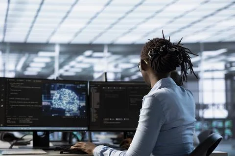 Computer scientist running code to upgrade artificial intelligence tech Stock Photos