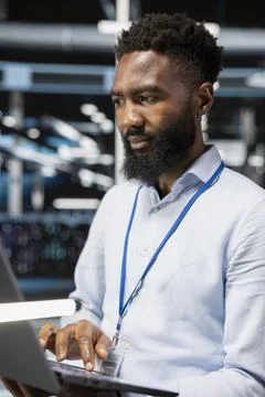 Computer scientist in server room doing data backup 写真素材